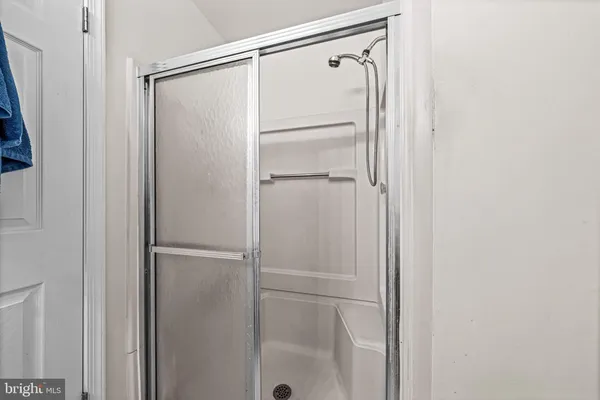 a bathroom with a glass shower door