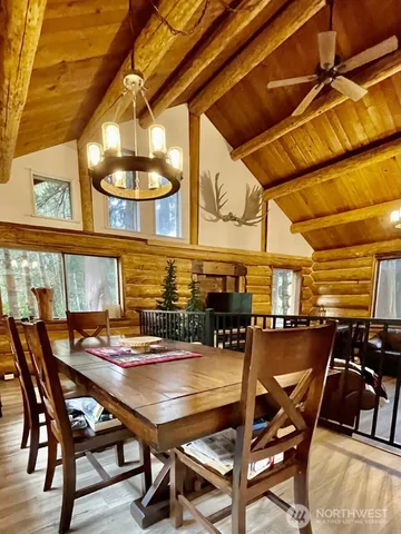 a view of a dining room with furniture and chandelier
