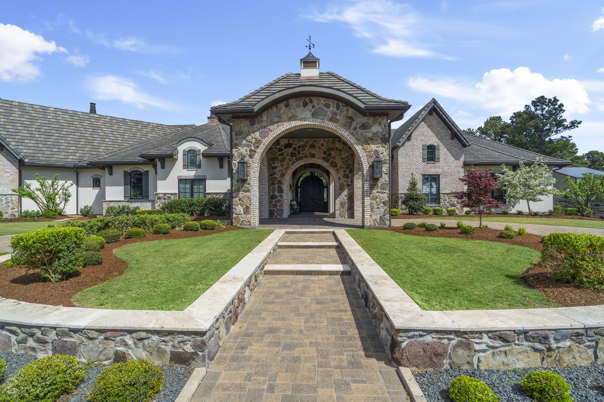 5 Willowcreek Ranch Road Tomball, TX 77377 - Photo 3 of 50 A private paved driveway framed by an elegant arched entry