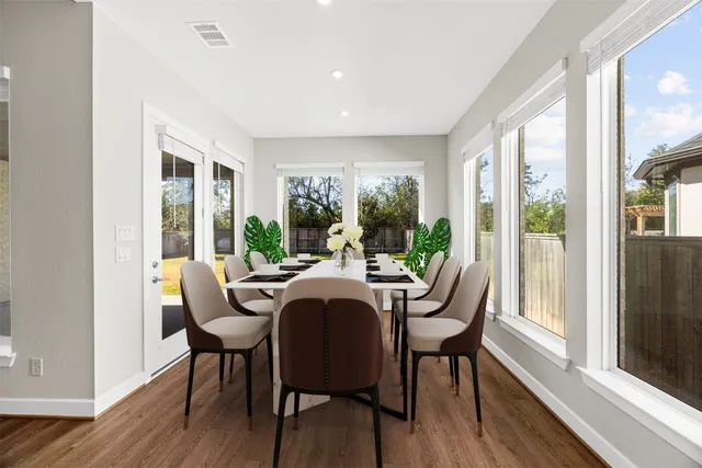 a dining room with furniture window and wooden floor