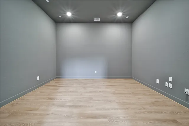 a bedroom with a bed a couch and a large window