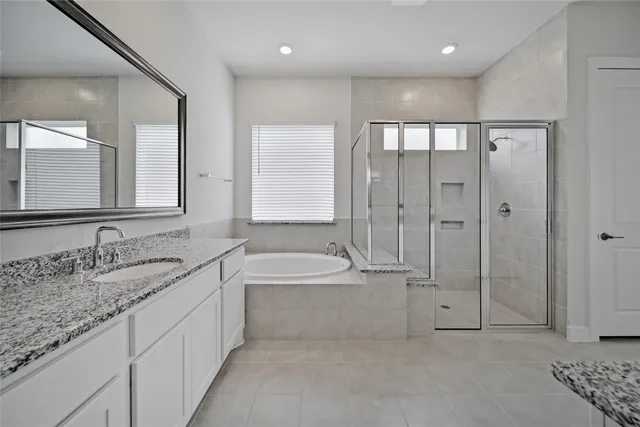 a bathroom with a double vanity sink and mirror