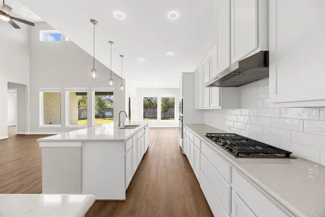 a kitchen with stainless steel appliances kitchen island a sink and a stove