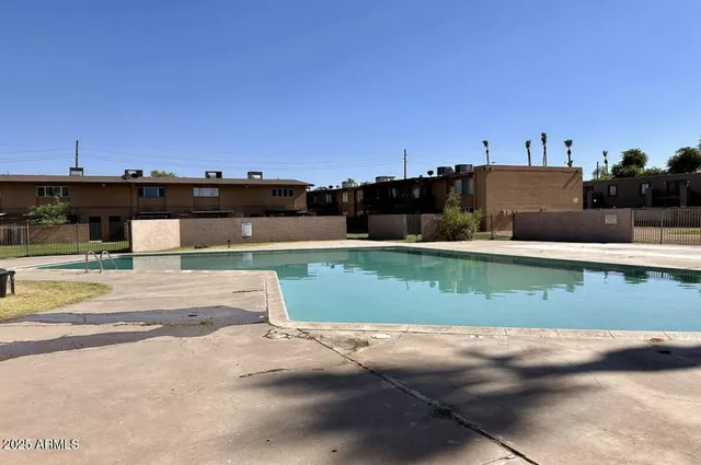 a view of a swimming pool and a yard