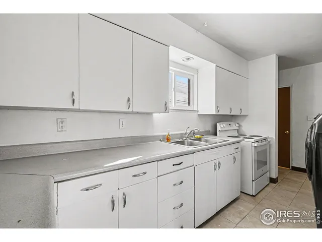 a kitchen with cabinets appliances and a sink
