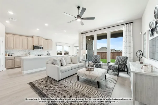 a living room with furniture appliances and a large window