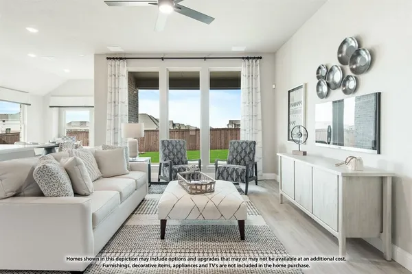 a living room with furniture a large window and a chandelier