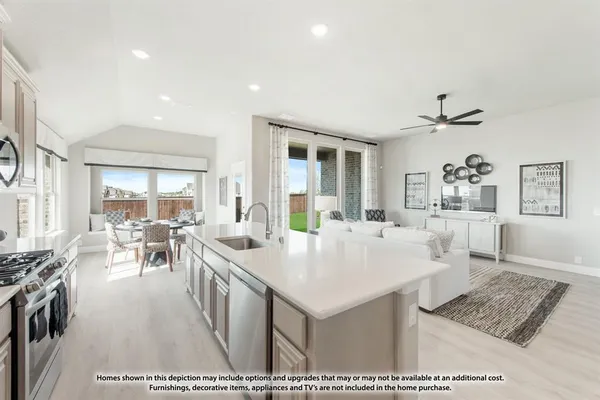 a very nice looking dining room with kitchen island a stove a table and chairs