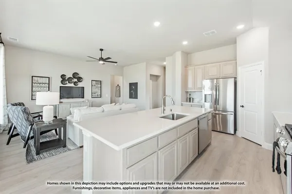 a large white kitchen with a sink and refrigerator