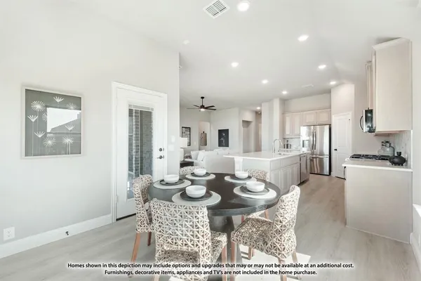 a open dining room with furniture a rug and kitchen view