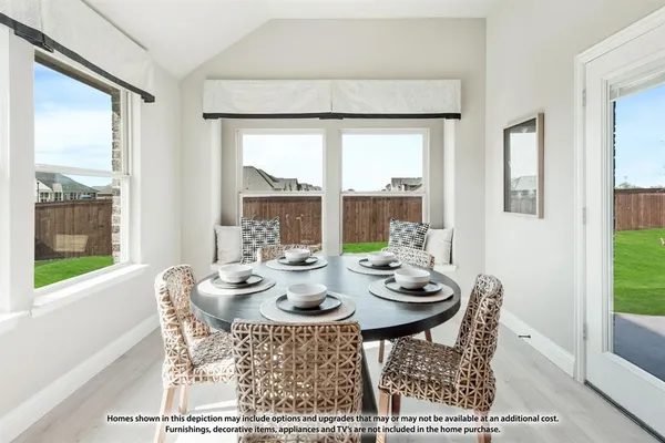 a view of a dining room with furniture large windows and wooden floor