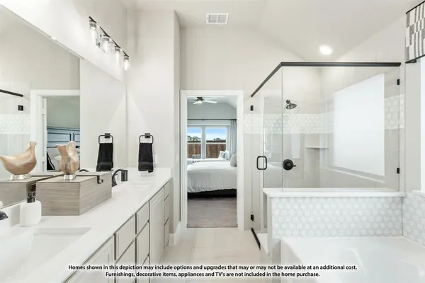a en suite bathroom with a double vanity sink a mirror and a shower