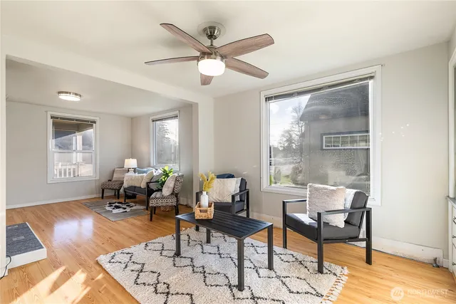 a living room with furniture and wooden floor