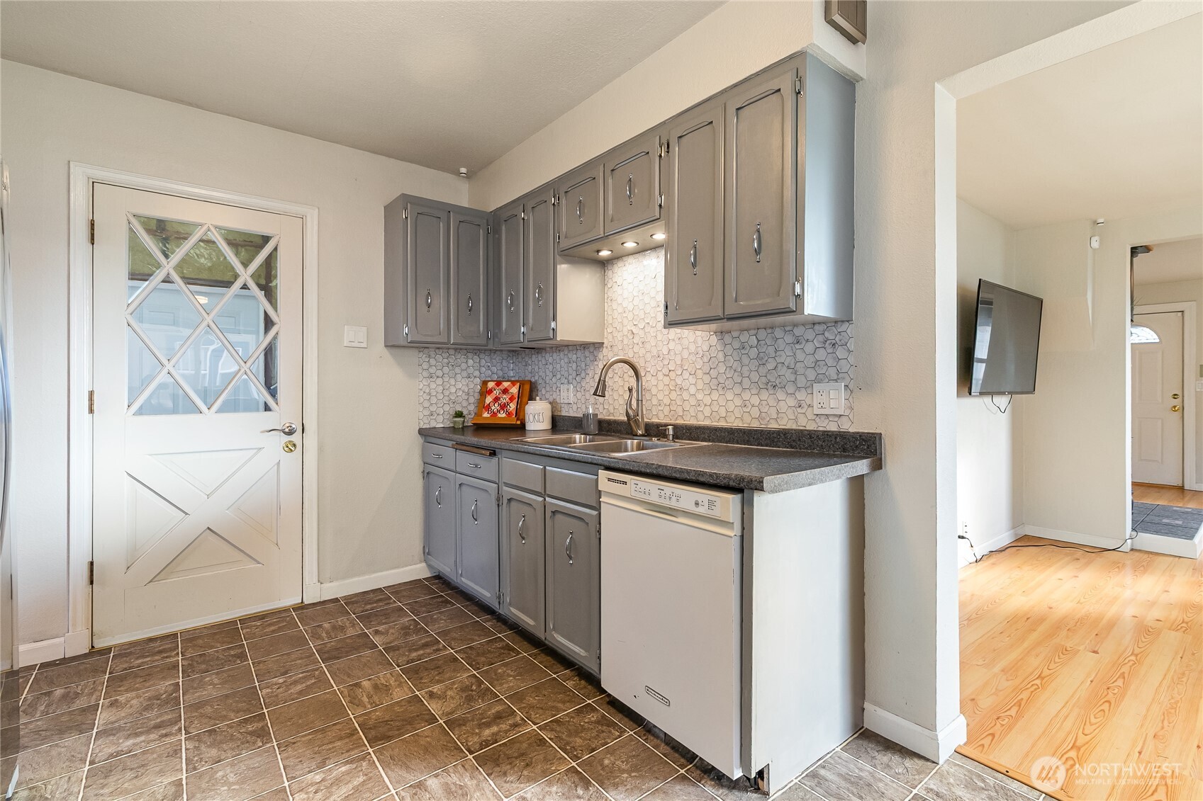 414 Edson Street Lynden, WA 98264 - Photo 24 of 32 a kitchen with stainless steel appliances granite countertop a stove a sink and a refrigerator with cabinets