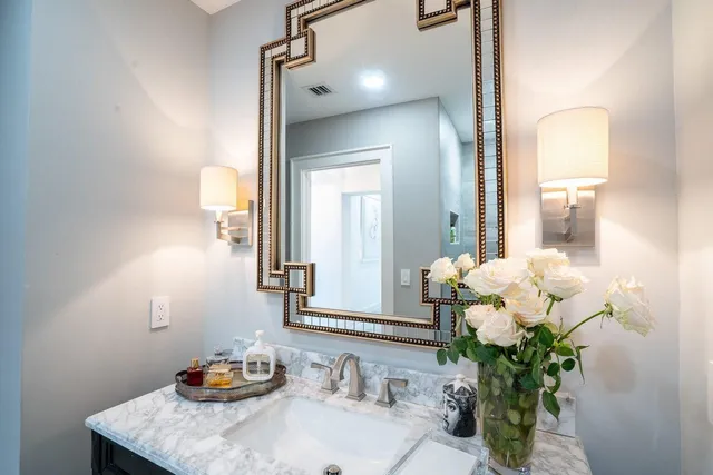 a bathroom with a sink a vanity and a mirror
