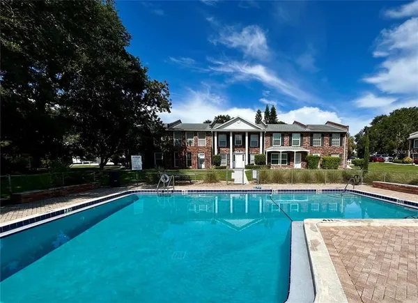 a view of a house with swimming pool and sitting area