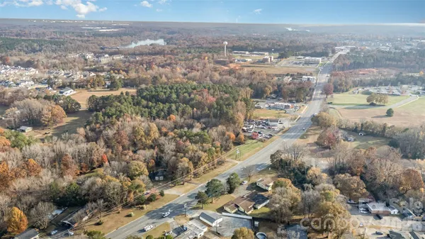 an aerial view of house with yard and mountain view in back