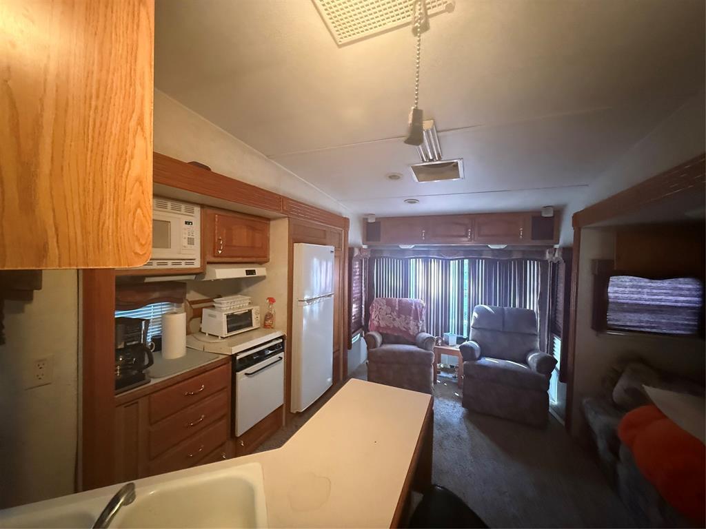 314 Blackjack Street Yantis, TX 75497 - Photo 25 of 26 a kitchen with stainless steel appliances kitchen island granite countertop a refrigerator a stove top oven a sink and dishwasher