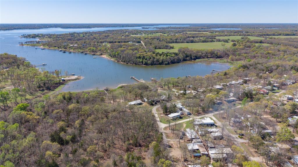 314 Blackjack Street Yantis, TX 75497 - Photo 3 of 26 an aerial view of ocean with residential house with outdoor space and trees around