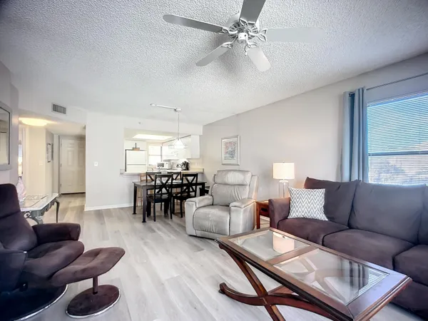 a living room with furniture a flat screen tv and a window