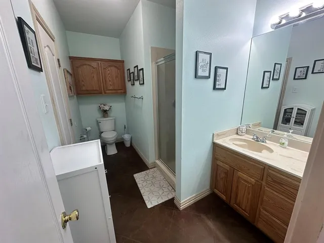 a bathroom with a sink a toilet and mirror