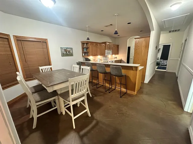 a dining room with furniture and window
