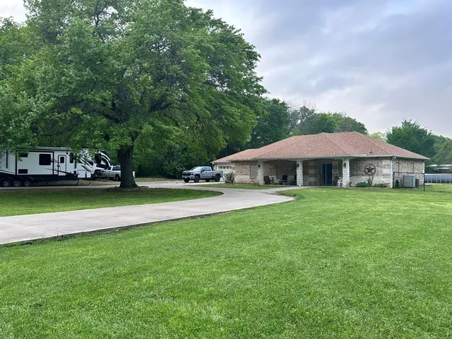 a view of house with swimming pool and yard