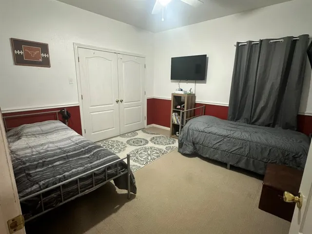 a bedroom with a bed and a flat screen television