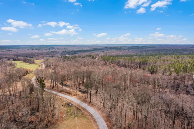 a view of a swimming pool with a yard and mountain view in back