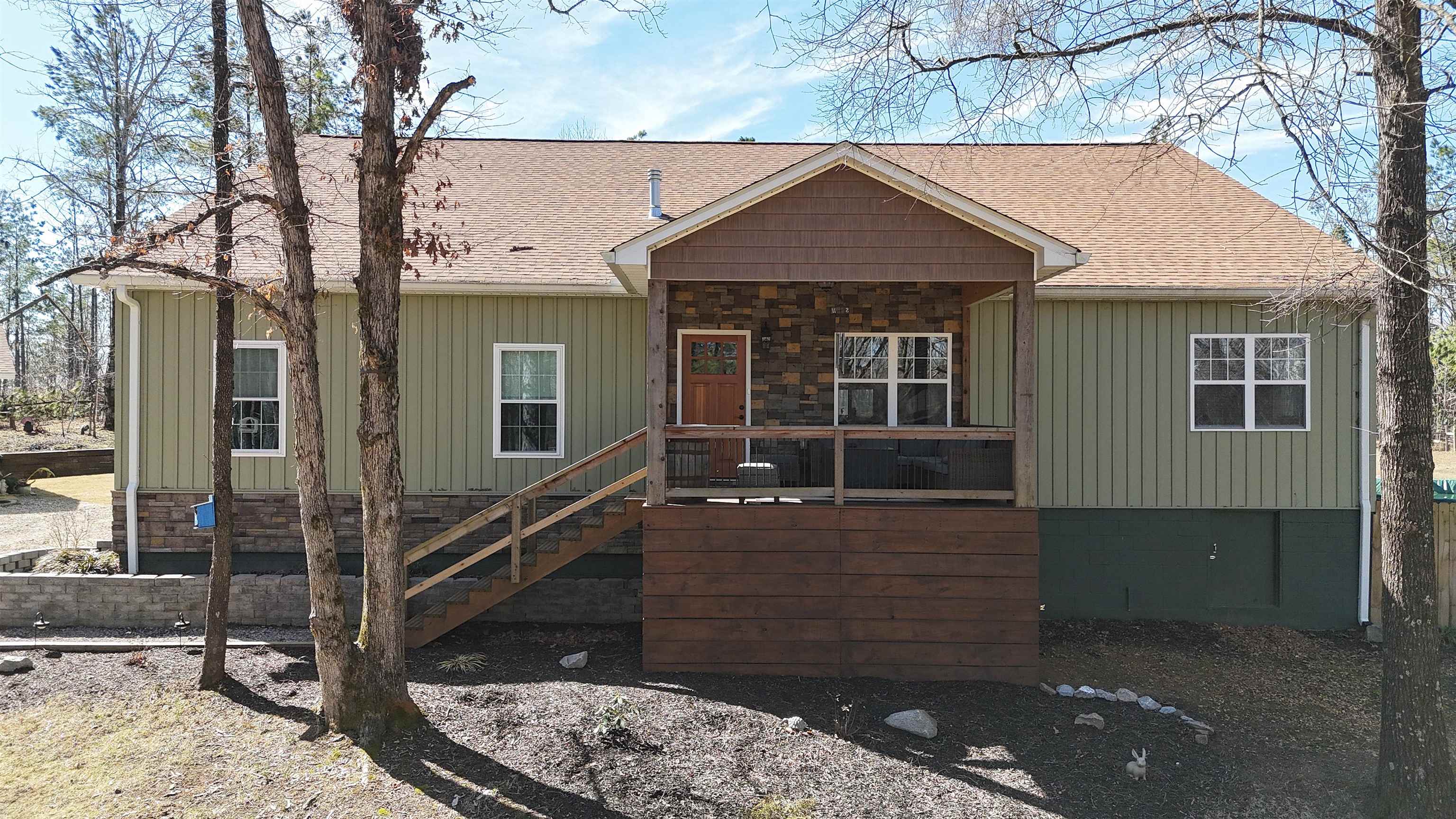 View of front of property featuring roof with shingles and board and batten siding