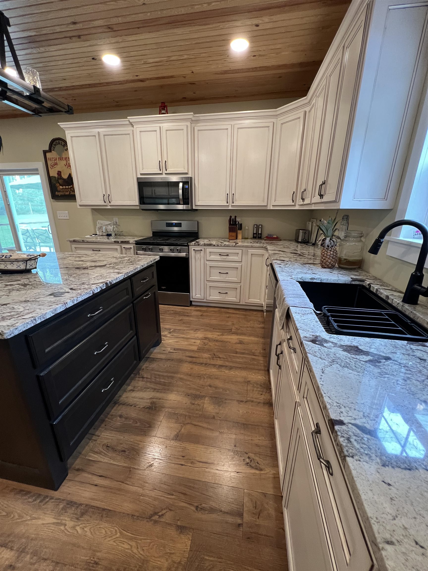 5205 Hamburg Road Michie, TN 38357 - Photo 11 of 40 a kitchen with granite countertop wooden cabinets and a stove top oven