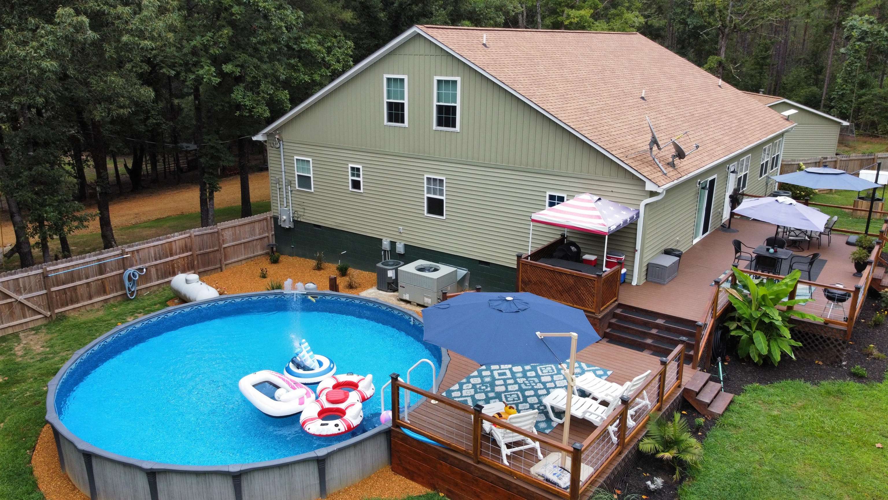 5205 Hamburg Road Michie, TN 38357 - Photo 28 of 40 View of pool with outdoor dining area, a deck, a fenced backyard, and a wooded view