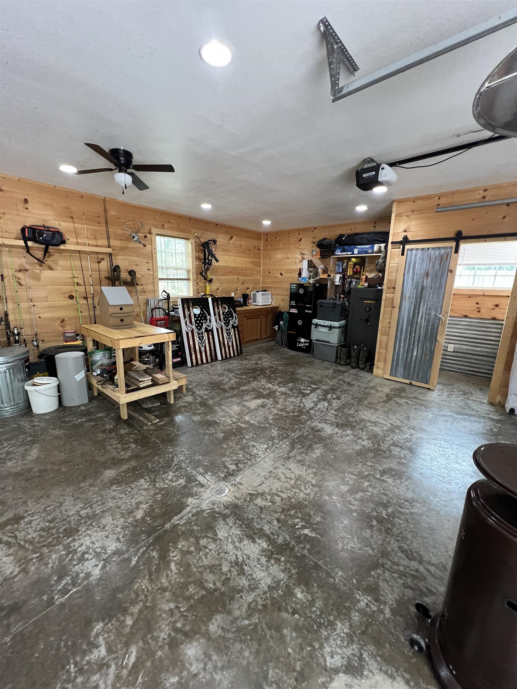 5205 Hamburg Road Michie, TN 38357 - Photo 38 of 40 Detached shop with a workshop area, wood walls, a garage door opener, and recessed lighting.