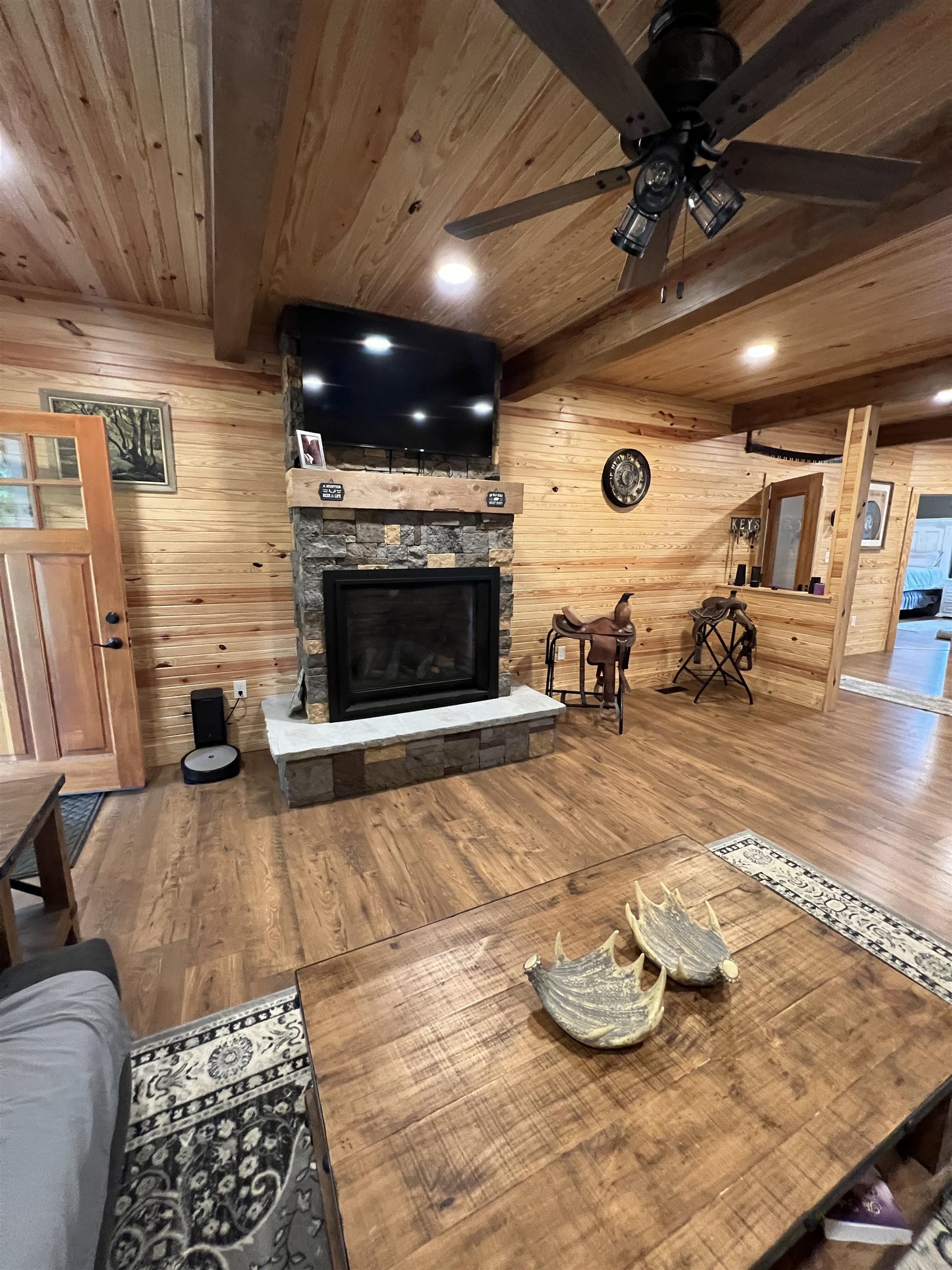 5205 Hamburg Road Michie, TN 38357 - Photo 6 of 40 Living room with a wood ceiling with exposed beams, a fireplace, wood walls, wood finished floors, and recessed lighting