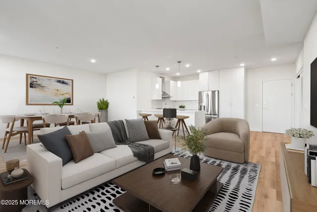 a living room with furniture kitchen view and a table