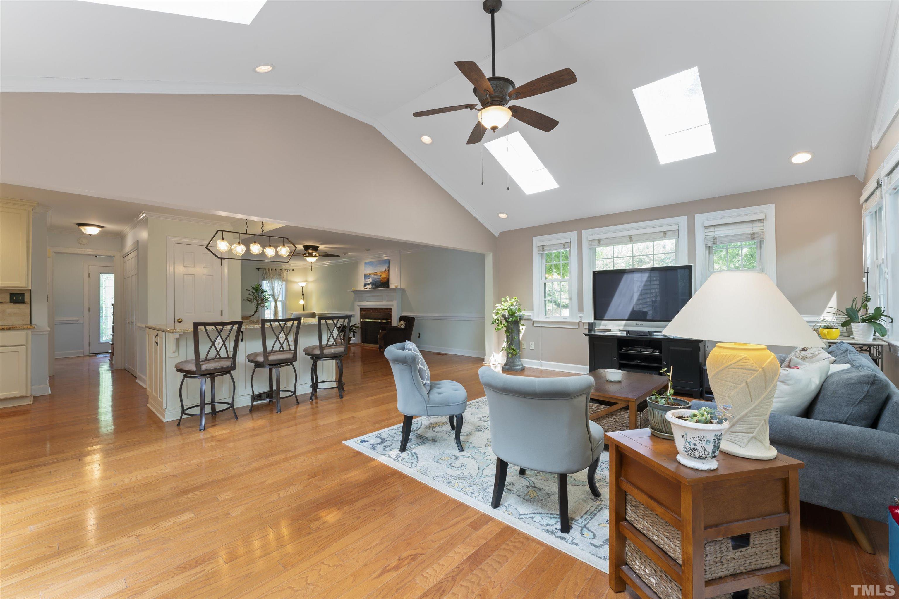 101 Vicksburg Drive Cary, NC 27513 - Photo 12 of 39 a living room with furniture a rug and a chandelier