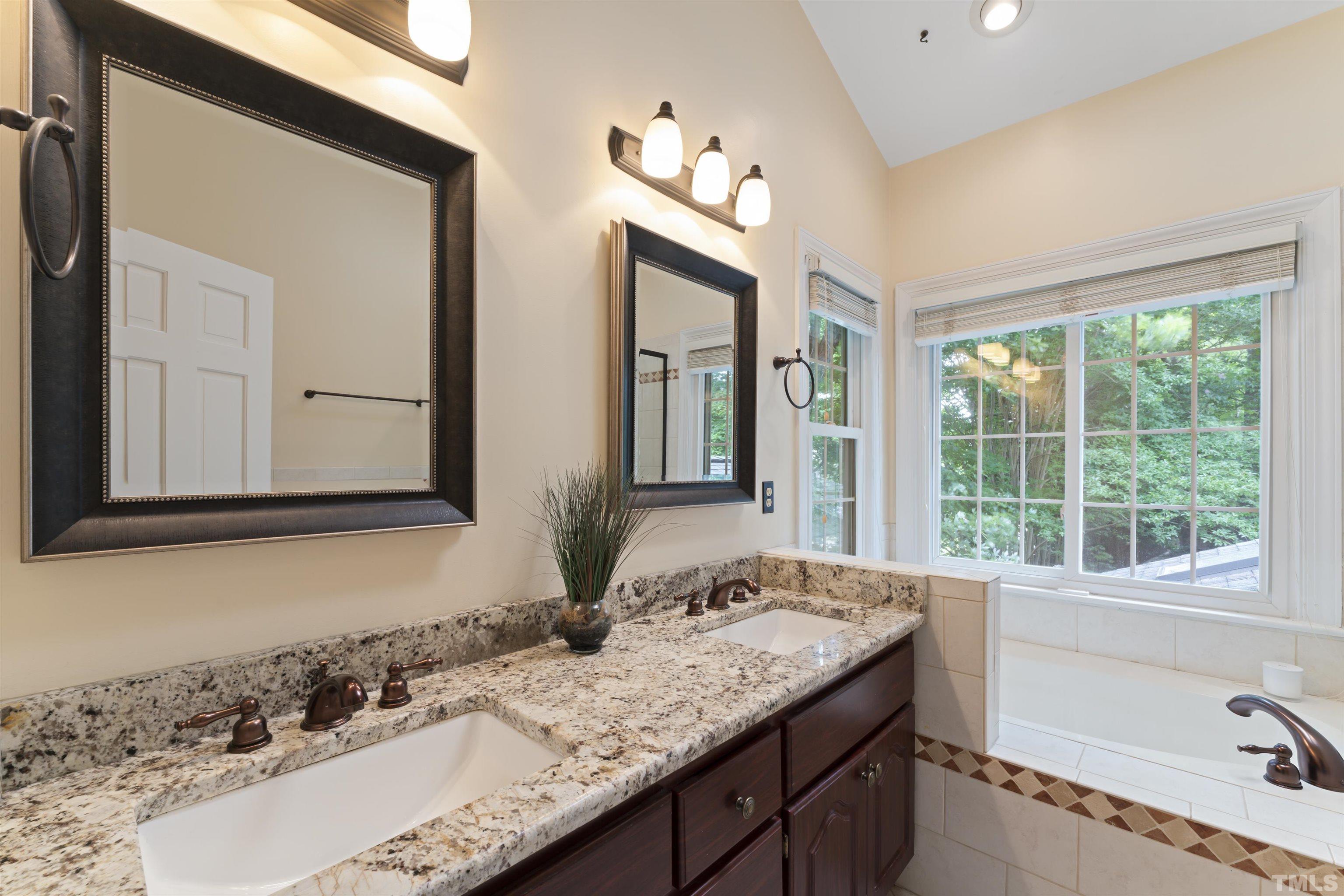 101 Vicksburg Drive Cary, NC 27513 - Photo 18 of 39 a bathroom with a granite countertop sink and a window