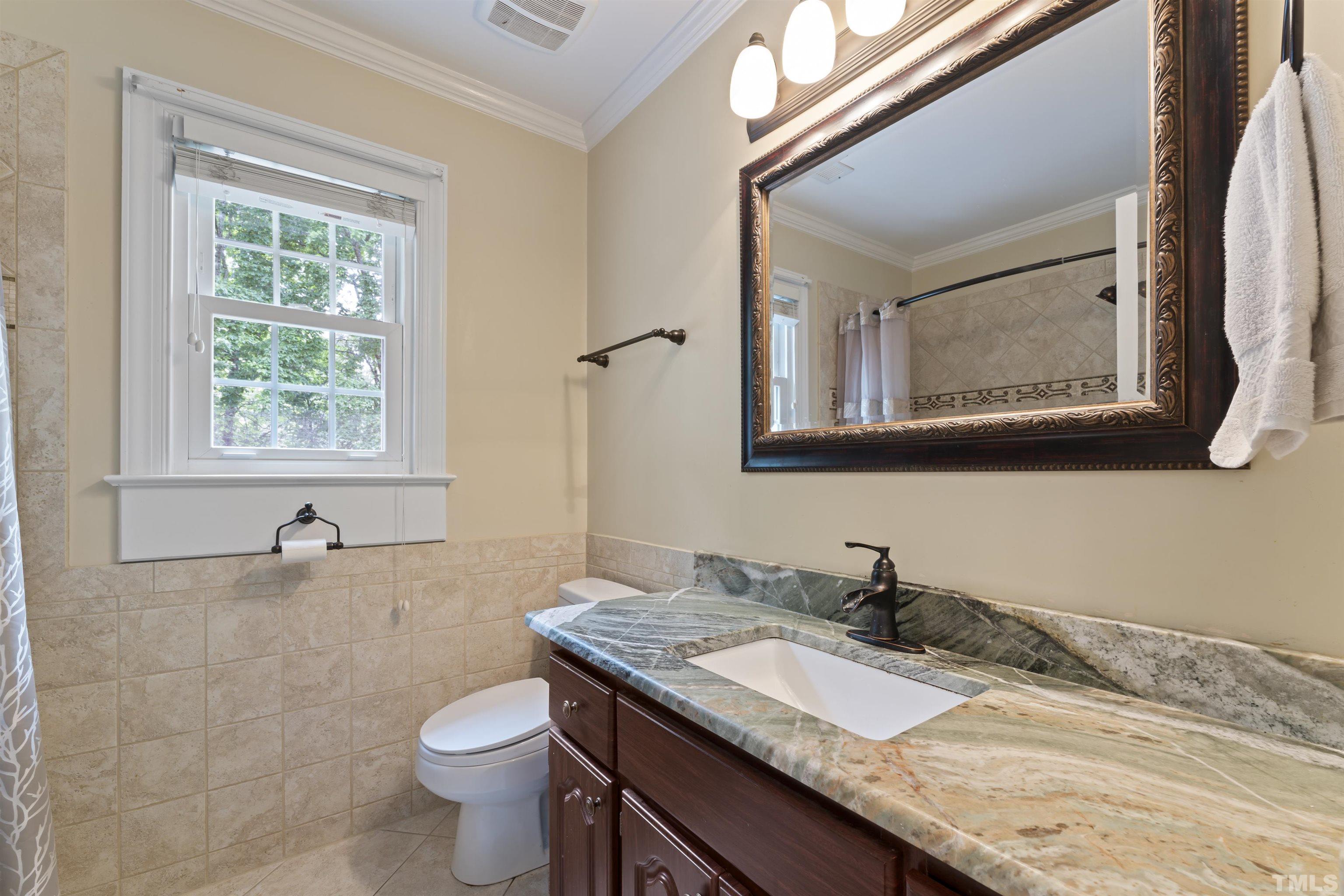 101 Vicksburg Drive Cary, NC 27513 - Photo 27 of 39 a bathroom with a granite countertop sink a toilet and mirror