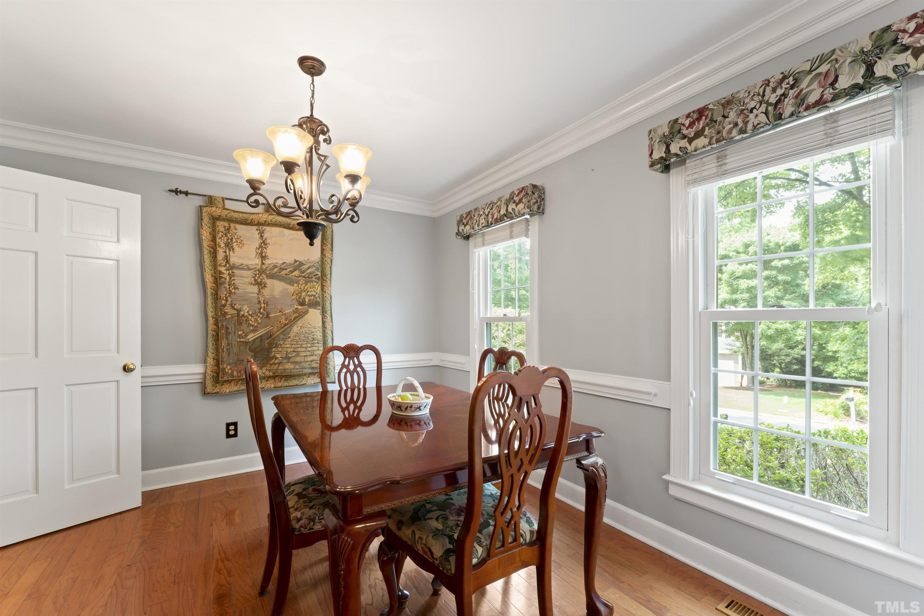 101 Vicksburg Drive Cary, NC 27513 - Photo 32 of 39 a view of a dining room with furniture wooden floor and chandelier