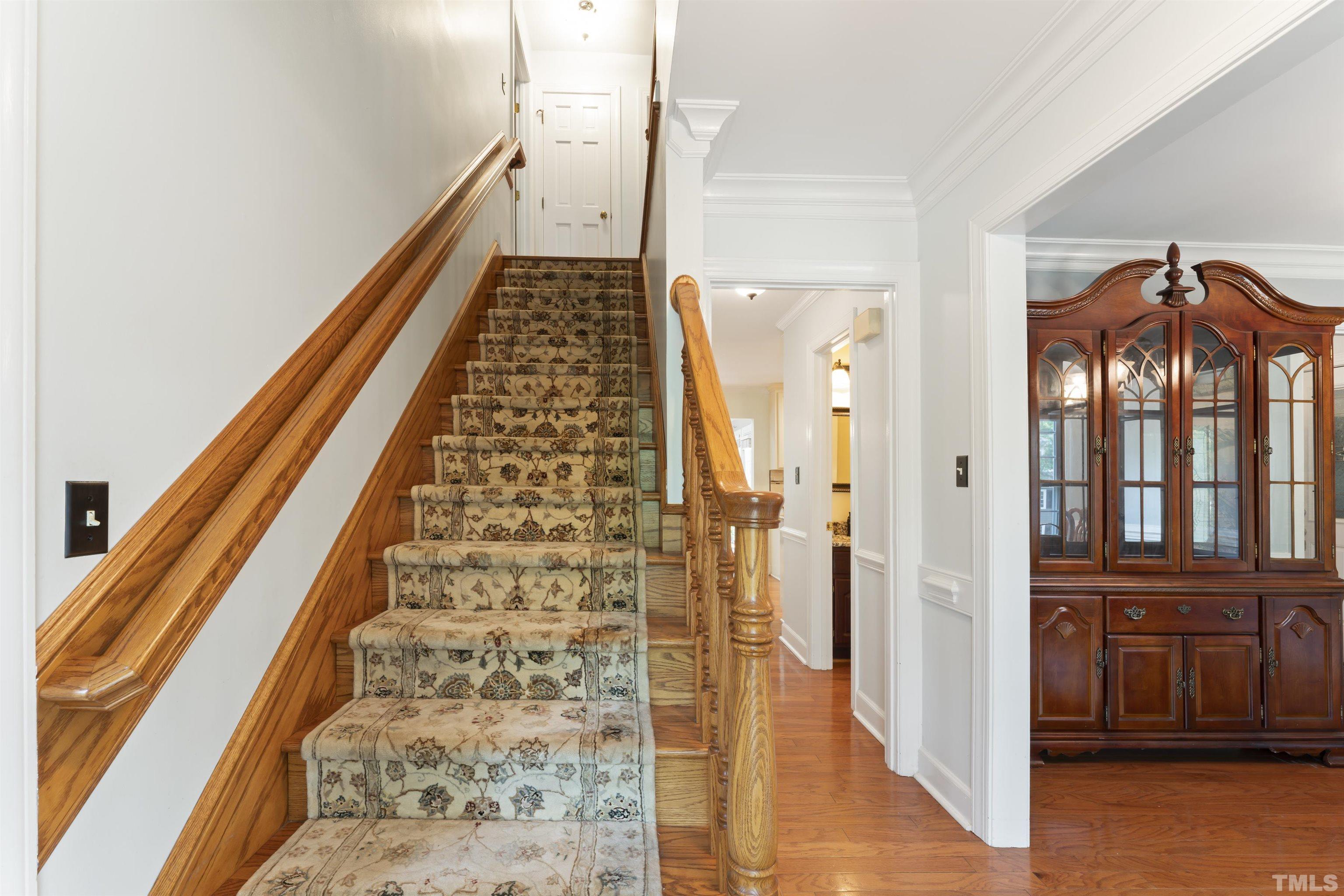 101 Vicksburg Drive Cary, NC 27513 - Photo 34 of 39 a view of a hallway with wooden floor and staircase