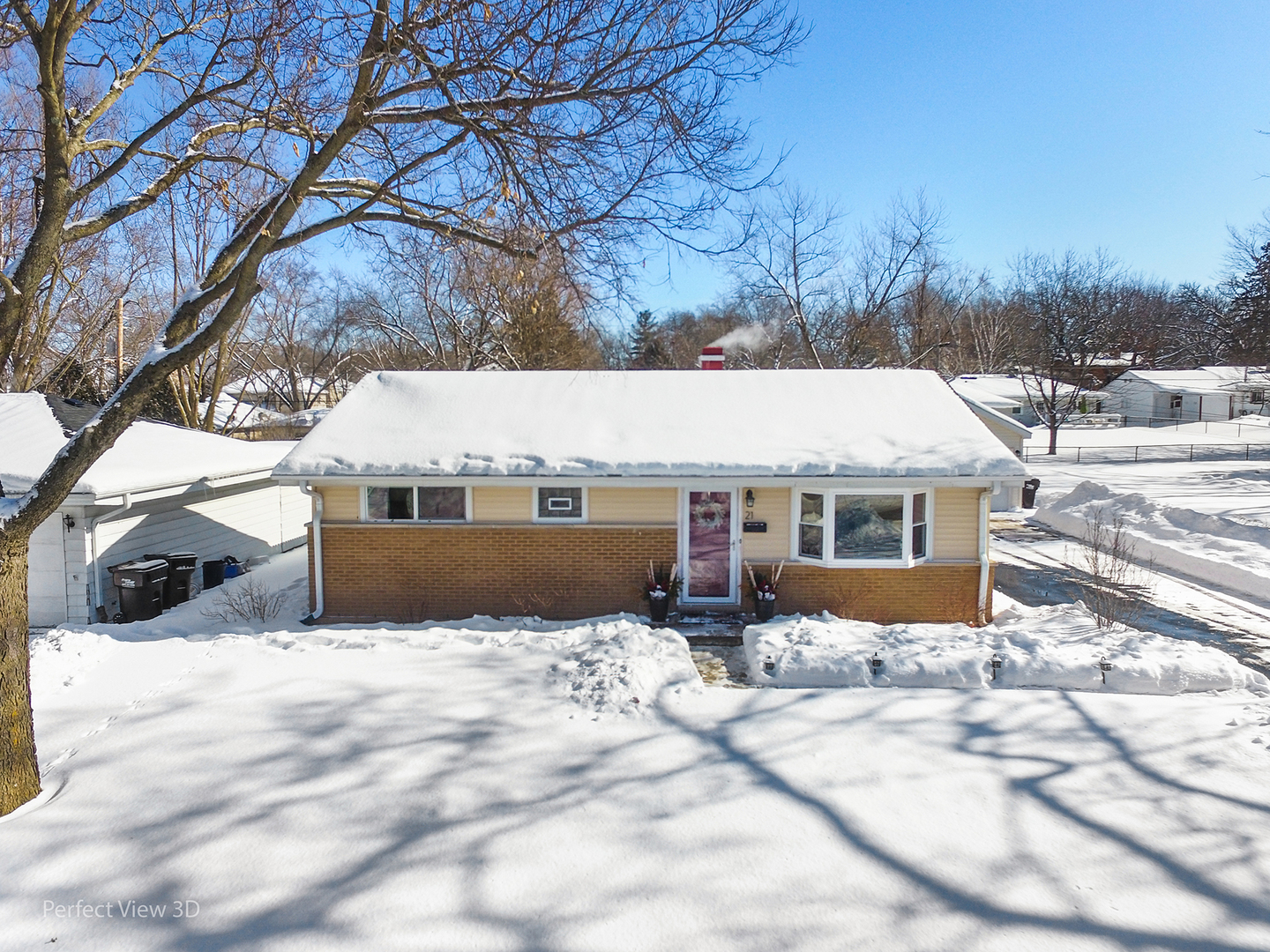 a view of a house with a yard covered in snow