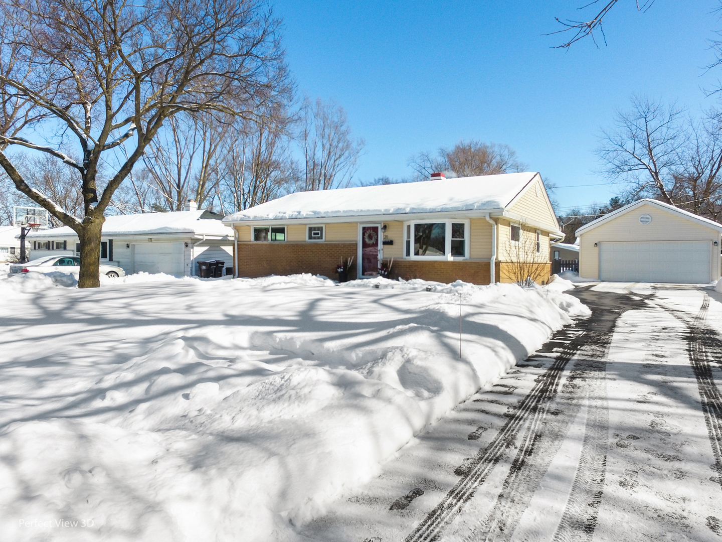 21 Crescent Road Lake Zurich, IL 60047 - Photo 2 of 24 a view of a white house with a yard covered in snow