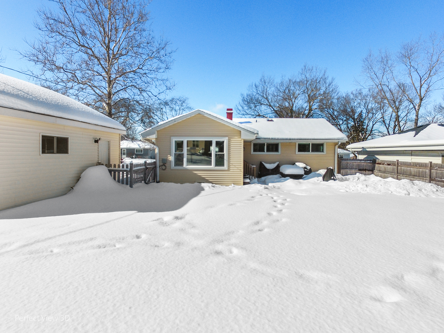 21 Crescent Road Lake Zurich, IL 60047 - Photo 23 of 24 a view of a white house with a yard covered in snow