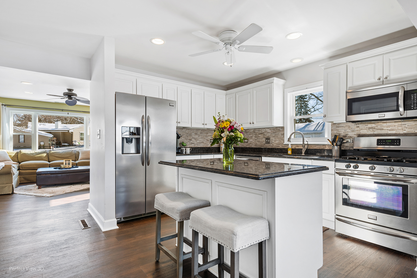 21 Crescent Road Lake Zurich, IL 60047 - Photo 7 of 24 a kitchen with stainless steel appliances granite countertop a refrigerator a stove a sink a dining table and chairs with wooden floor