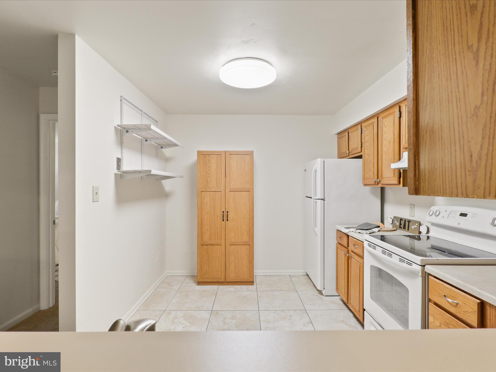 11713 Karbon Hill Court, Unit 710A Reston, VA 20191 - Photo 15 of 19 a kitchen with stainless steel appliances a refrigerator sink and cabinets