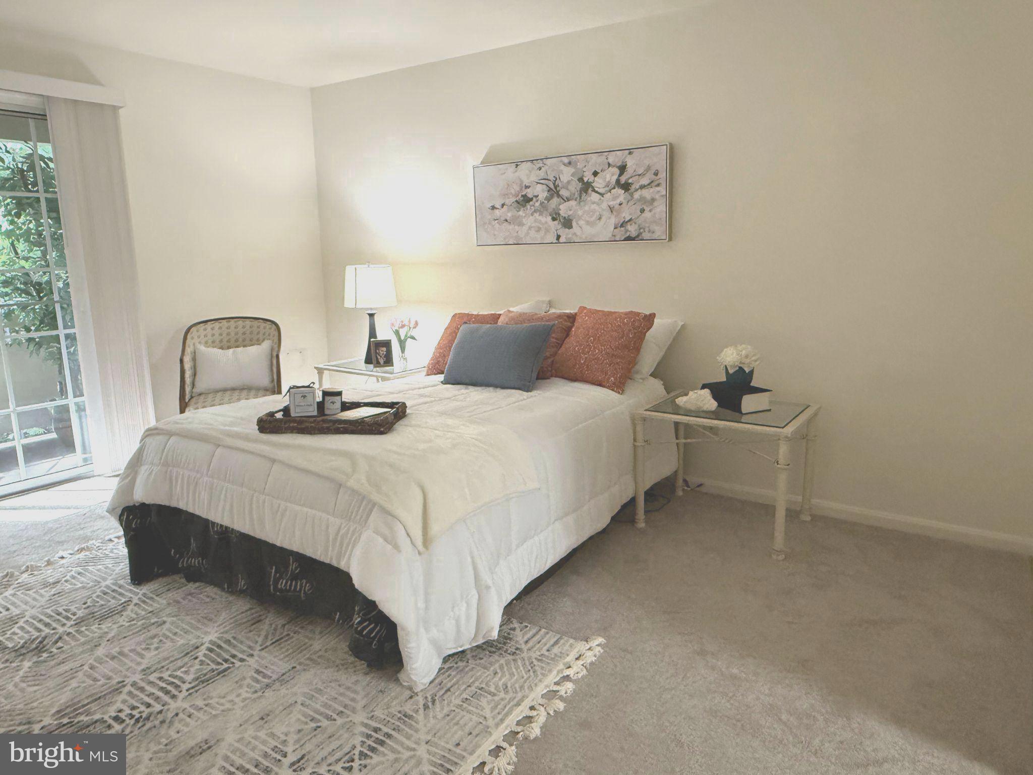 11713 Karbon Hill Court, Unit 710A Reston, VA 20191 - Photo 7 of 19 a bedroom with a bed and a table in it