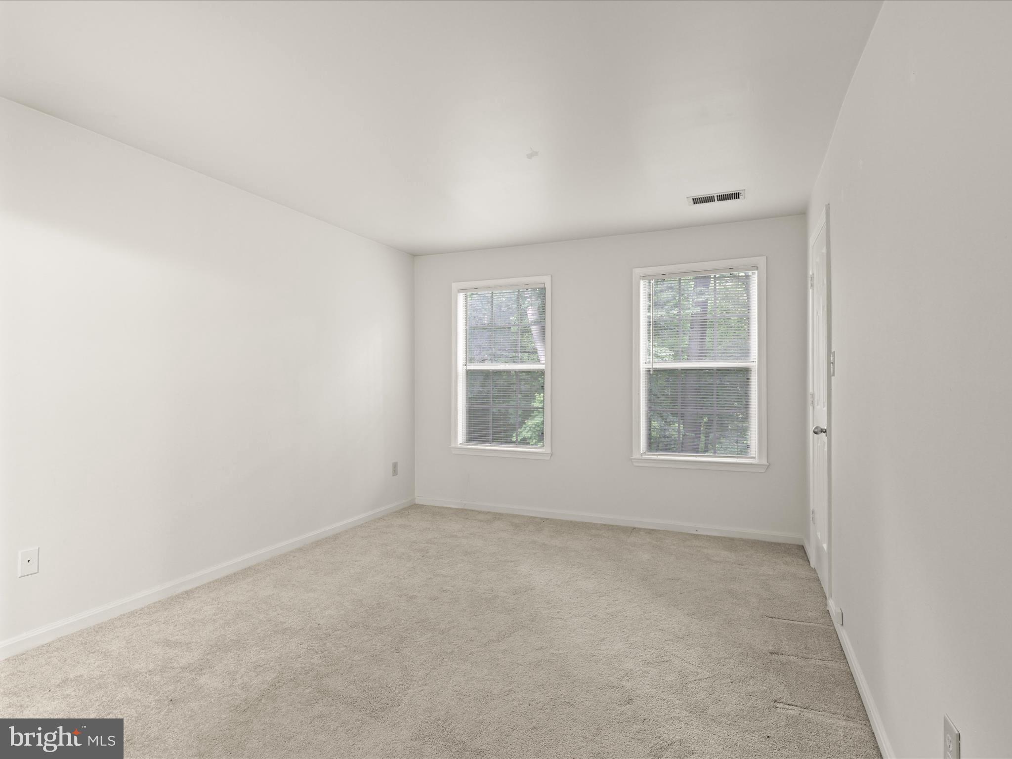 11713 Karbon Hill Court, Unit 710A Reston, VA 20191 - Photo 10 of 19 an empty room with windows