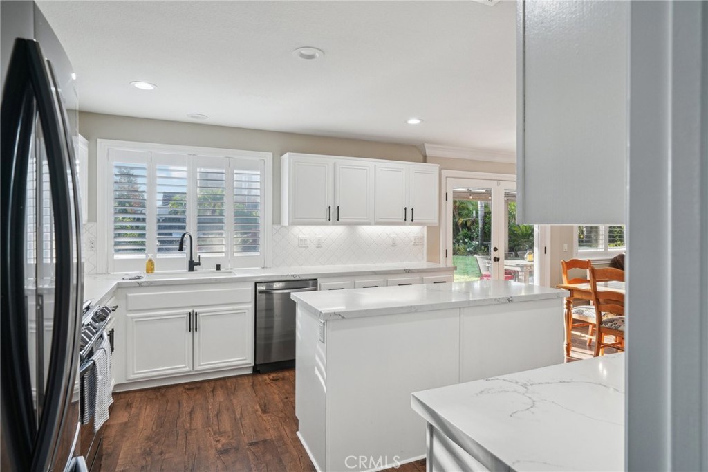 2575 Gilbert Avenue Corona, CA 92881 - Photo 16 of 58 a kitchen with appliances cabinets and a sink