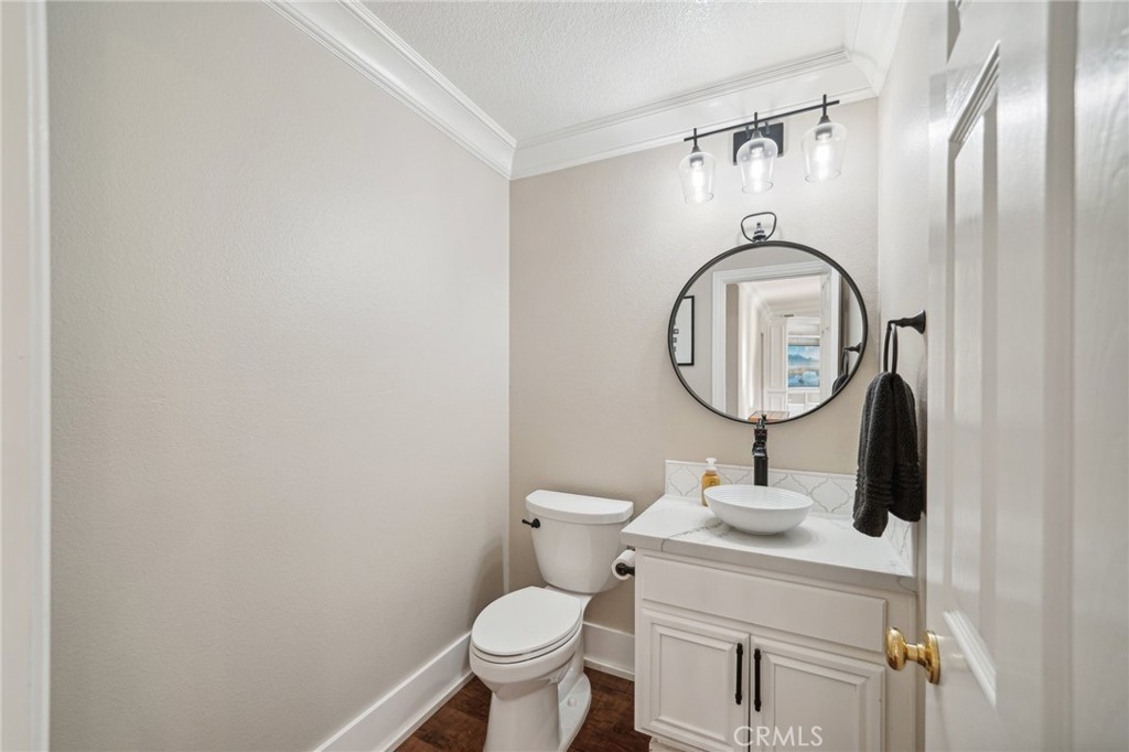 2575 Gilbert Avenue Corona, CA 92881 - Photo 18 of 58 a bathroom with a toilet mirror and sink