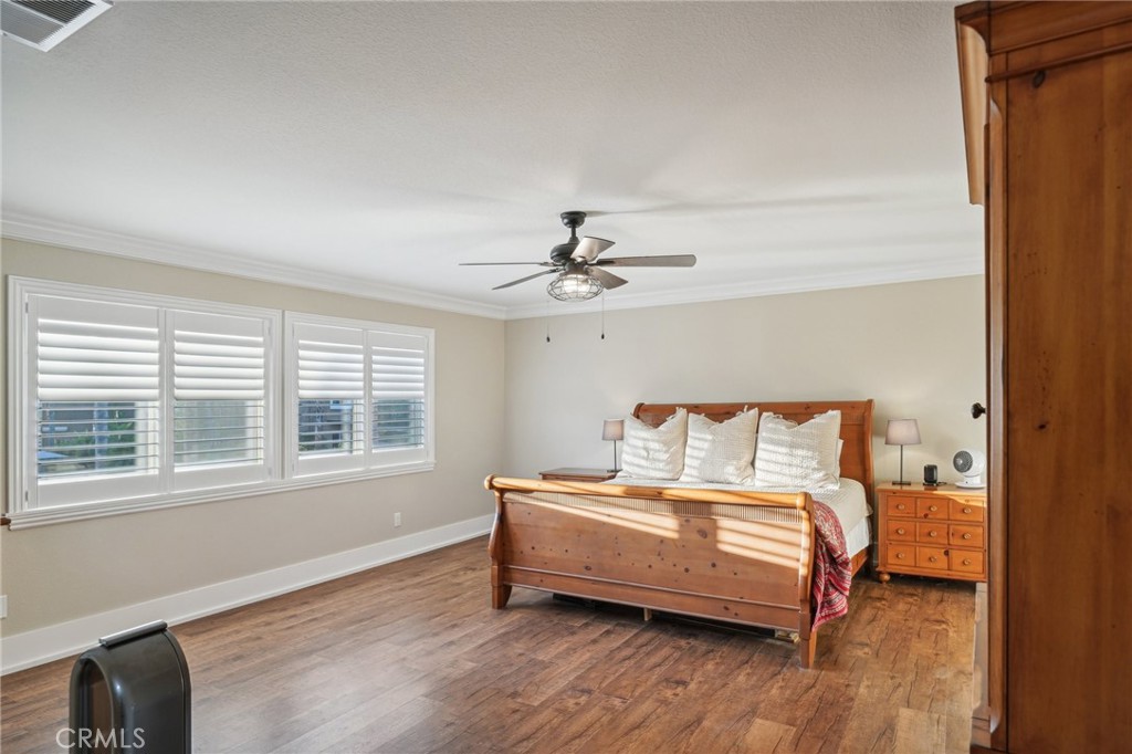 2575 Gilbert Avenue Corona, CA 92881 - Photo 29 of 58 a bedroom with a bed wooden floor and window